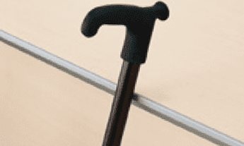 A walking stick rests securely on the edge